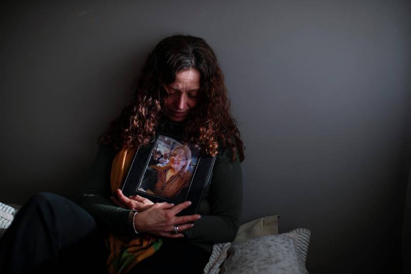 Fernanda Mariotti cradles a picture of her mother Martha Pedrotti, who died of Covid-19, at her home in Buenos Aires, Argentina. AP Photo