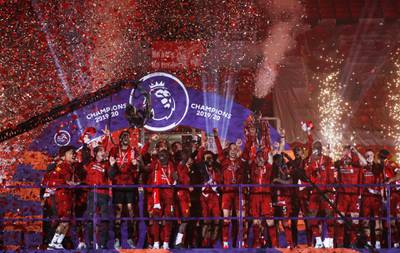 Liverpool celebrate with the trophy. Reuters