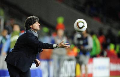 Germany's coach Joachim Loew throws the ball to a player during the third place World Cup 2010 football match Uruguay versus Germany on July 10, 2010 at Nelson Mandela Bay stadium in Port Elizabeth. Germany won the match 3-2.  NO PUSH TO MOBILE / MOBILE USE SOLELY WITHIN EDITORIAL ARTICLE  - AFP PHOTO / JOHN MACDOUGALL (Photo by JOHN MACDOUGALL / AFP)