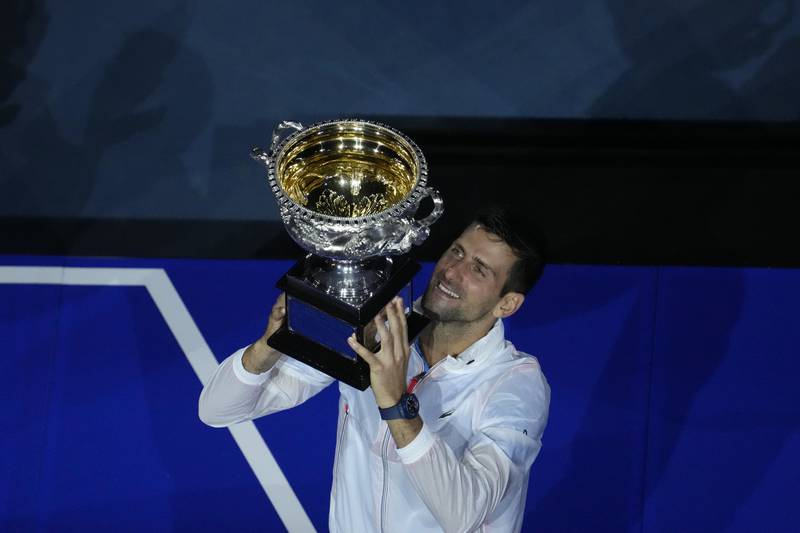 Novak Djokovic of Serbia lifts the trophy after beating Stefanos Tsitsipas of Greece 6-3, 7-6, 7-6 to win his 10th Australian Open singles title - and a record-equalling 22nd Grand Slam crown - in Melbourne on Sunday, January 29, 2023.  AP 