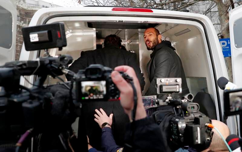Social media influencer Andrew Tate in the back of a police van in Bucharest, Romania. EPA