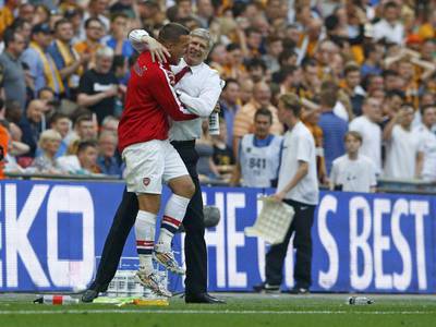 Arsenal's Lukas Podolski hugs manager Arsene Wenger as they celebrate their victory against Hull City in the FA Cup final at Wembley Stadium on Saturday. Darren Staples / Reuters / May 17, 2014                 