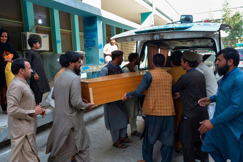 Relatives carry the coffin of a victim, who was killed in a stampede, outside a mortuary in Jalalabad on October 21, 2020. At least 11 women were killed on October 21 in a stampede at a stadium in eastern Afghanistan where thousands had gathered to apply for visas at a nearby Pakistan consulate, officials said. / AFP / NOORULLAH SHIRZADA
