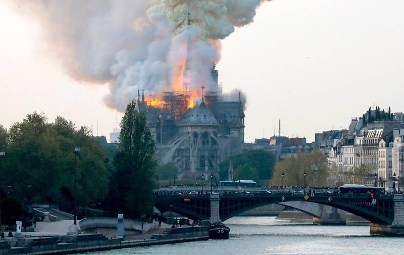 Smoke and flames rise from Notre Dame Cathedral in central Paris on April 15, 2019. AFP