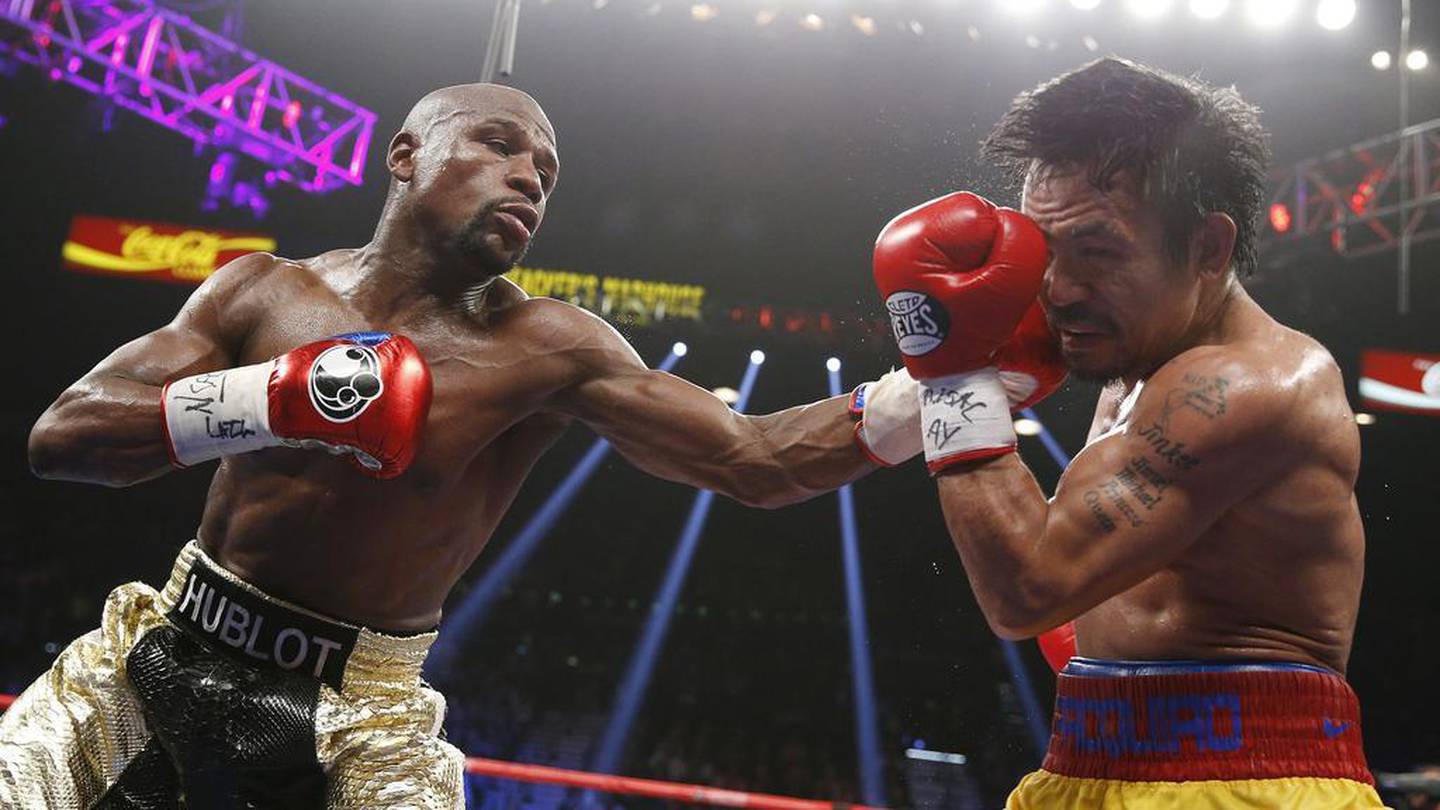Floyd Mayweather Jr, left, lands a left to the head of Manny Pacquiao, during their welterweight title fight on Saturday, May 2, 2015 in Las Vegas. AP Photo