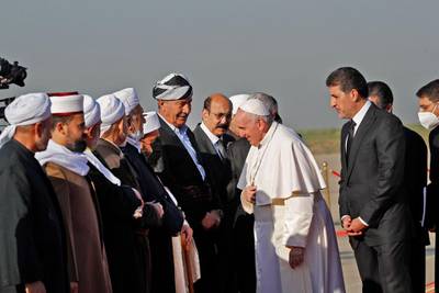 Mansour Barzani, Prime Minister of the 9th cabinet of the Kurdistan Regional Government looks on , as Pope Francis greets religious dignitaries at the Erbil airport. AFP