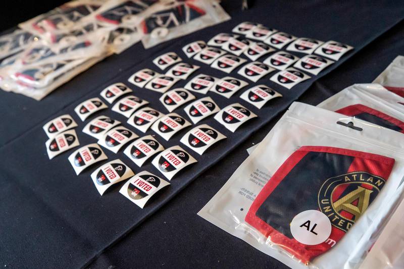 Voters were offered custom stickers and cloth face masks after participating in the final voting at the Mercedes-Benz Stadium for Georgia's US Senate runoff election in Atlanta, Georgia. EPA