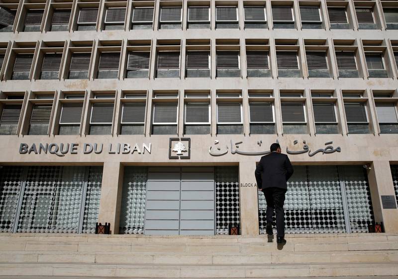 A man heads to the Lebanese central bank, in Beirut, Lebanon, Tuesday, Jan. 22, 2019. Lebanon's finance minister says a report by Moody's Investors Service that downgraded the country's long-term investment ratings reflect the need for quickly forming a new government and implement financial reform. Ali Hassan Khalil's tweet on Tuesday came hours after Moody's downgraded the Lebanon's issuer ratings to Caa1 from B3. (AP Photo/Hussein Malla)