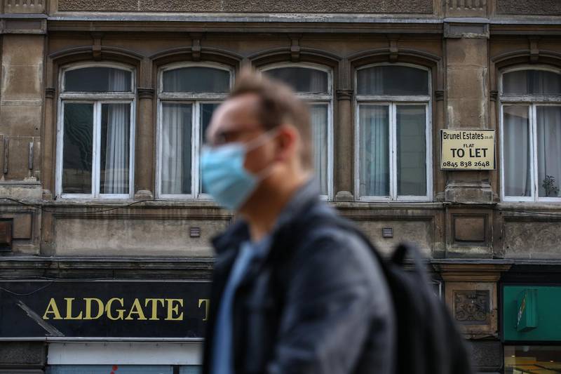 A pedestrian walks past a "To Let" sign displayed on a building in Aldgate in London, England. Aldgate has seen a 34% fall in price per room. Getty Images
