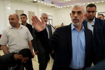 Yahya Sinwar, head of Hamas in Gaza, greets his supporters upon his arrival at a public meeting in Gaza City. AP