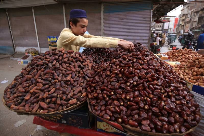 A vendor sells dates in Peshawar. EPA