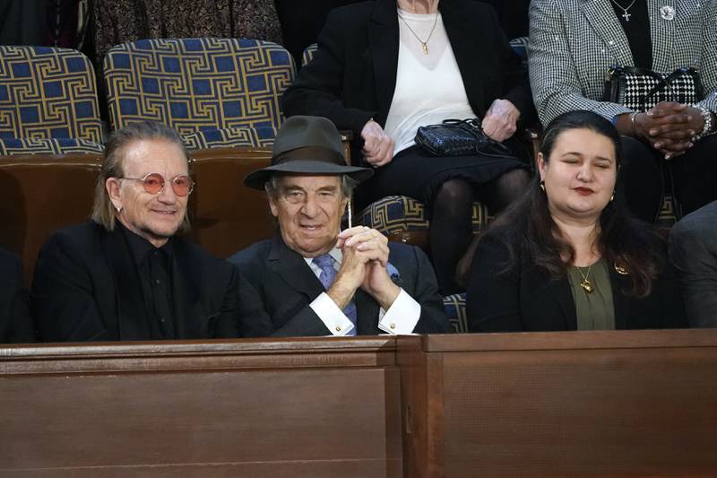 From left, U2 lead singer Bono, Paul Pelosi, husband of former House speaker Nancy Pelosi, and Marie Yovanovitch, US Ambassador to Ukraine, sit in the gallery before the start of the address. AP