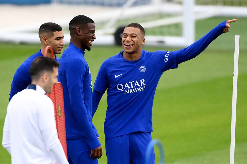 PSG defender Nordi Mukele, centre, shares a laugh with Kylian Mbappe on Tuesday. AFP