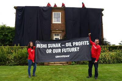 Greenpeace activists on the roof of UK Prime Minister Rishi Sunak's manor house in Kirby Sigston, northern England, to protest at his backing for new oil and gas licences in the North Sea. AFP