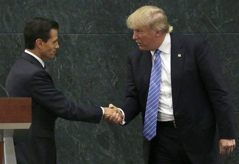 Mexico President Enrique Pena Nieto and Republican presidential nominee Donald Trump shake hands after a joint statement at Los Pinos, the presidential official residence, in Mexico City. Trump is calling his surprise visit to Mexico City Wednesday a 'great honour.'  Marco Ugarte / AP