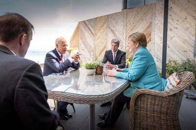 German Chancellor Angela Merkel and US President Joe Biden at the beginning of their meeting on the sidelines of the G7 summit. AFP