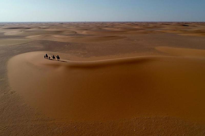 A drone captures the team travelling in the Empty Quarter desert from above