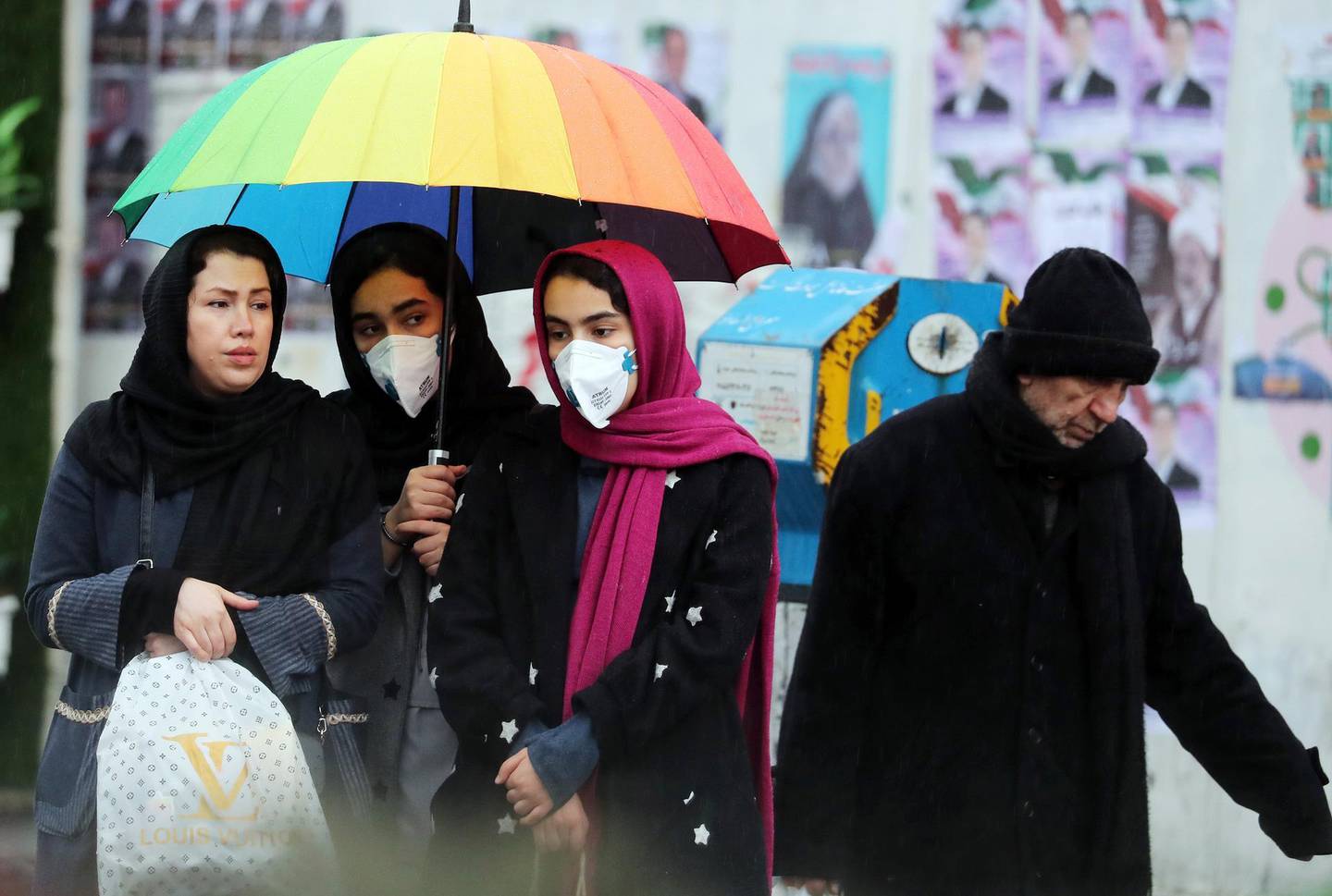 epa08230871 Iranian women wearing masks wait for a taxi in a street of Tehran, Iran, 20 February 2020. According to the Ministry of Health, two people diagnosed with coronavirus died in the city of Qom, central Iran. The disease caused by the virus (SARS-CoV-2) has been officially named COVID-19 by the World Health Organization (WHO).  EPA/ABEDIN TAHERKENAREH