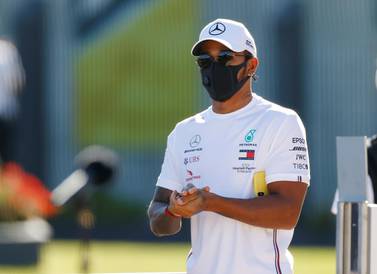 Formula One F1 - British Grand Prix - Silverstone Circuit, Silverstone, Britain - July 30, 2020 Mercedes' Lewis Hamilton washes his hands as he wears a protective face mask in the paddock ahead of the British Grand Prix REUTERS/Andrew Boyers