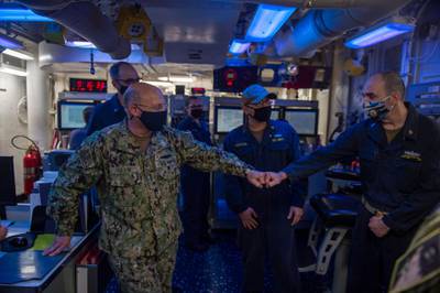 210113-N-XG173-1124 ARABIAN GULF (Jan. 13, 2020) Adm. Mike Gilday, chief of naval operations, left, greets Chief Gas Turbine System Technician Tyronn Hampton aboard the guided-missile destroyer USS John Paul Jones (DDG 53), in the Arabian Gulf, Jan. 13. John Paul Jones is part of the Nimitz Carrier Strike Group and is deployed to the U.S. 5th Fleet area of operations in support of naval operations to ensure maritime stability and security in the Central Region, connecting the Mediterranean and the Pacific through the western Indian Ocean and three strategic choke points critical to the free flow of global commerce. (U.S. Navy photo by Mass Communication Specialist 2nd Class Aja Bleu Jackson)