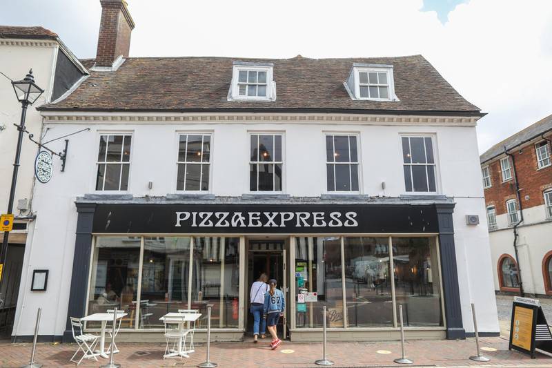 Customers enter a Pizza Express Ltd. restaurant in Ashford, U.K., on Friday, Aug. 21, 2020. U.K. consumer confidence remained weak in August as the specter of unemployment hung over the British economy. Photographer: Chris Ratcliffe/Bloomberg