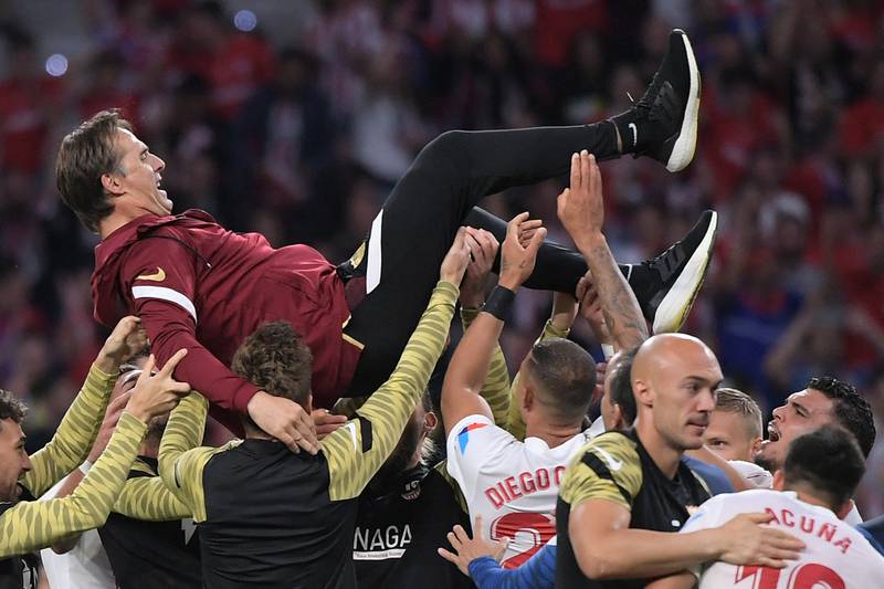 Sevilla manager Julen Lopetegui is tossed in the air by his players after the draw against Atletico Madrid ensured the club's place in next season's Champions League. AFP