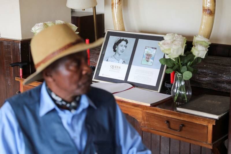 Amos Ndegwa sits in front of the condolence book in the Treetops Hotel in which Queen Elizabeth stayed the night her father George VI died in 1952, in Aberdare National Park, Kenya. Reuters