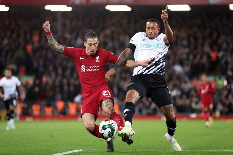 Kostas Tsimikas of Liverpool battles for possession with Nathaniel Mendez-Laing of Derby County. Getty