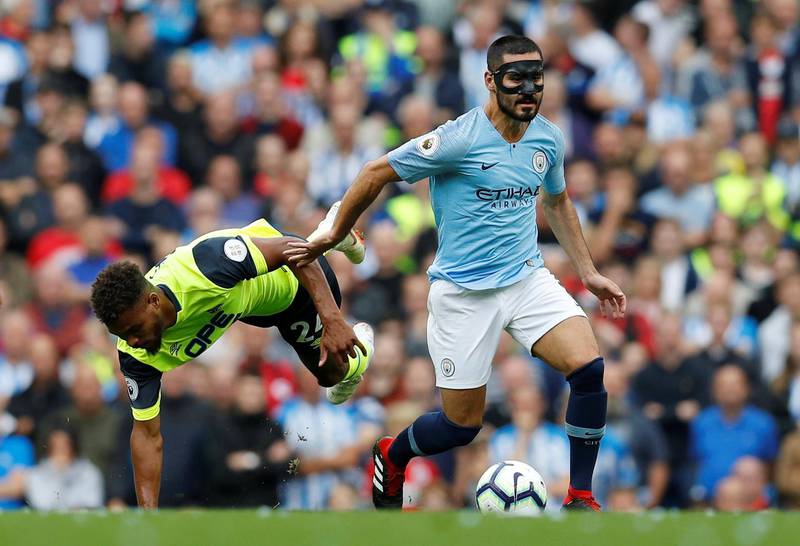 Manchester City's Ilkay Gundogan in action with Huddersfield Town's Steve Mounie. Reuters