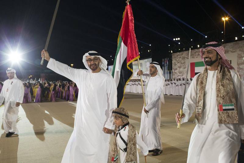 Sheikh Mohammed bin Zayed, Crown Prince of Abu Dhabi and Deputy Supreme Commander of the UAE Armed Forces, left, Sheikh Tahnoon bin Mohamed bin Tahnoon Al Nahyan, centre, and Sheikh Ammar bin Humaid Al Nuaimi, Crown Prince of Ajman, right, dance during celebrations at Adnec. Ryan Carter / Crown Prince Court - Abu Dhabi