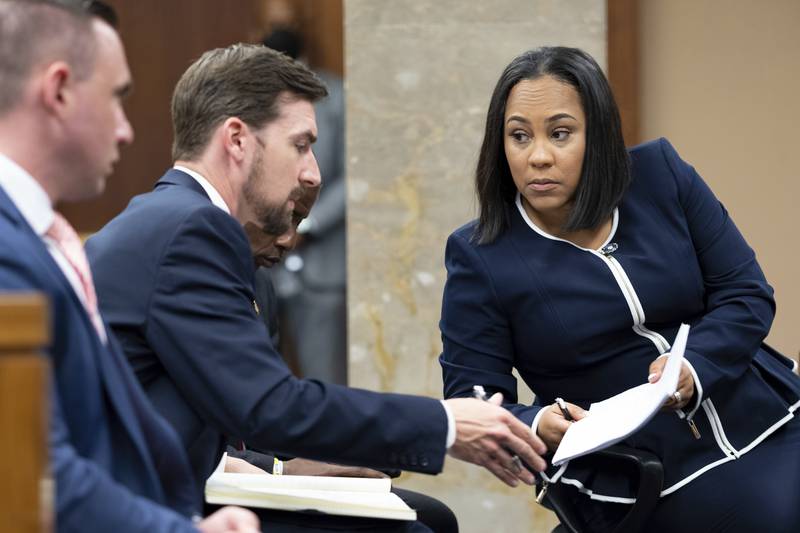 Fulton County District Attorney Fani Willis talks with a member of her team during proceedings to look into the actions of former President Donald Trump and his supporters who tried to overturn the results of the 2020 election. AP