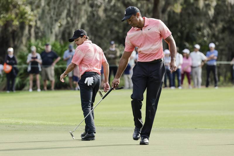 Tiger and Charlie Woods on the ninth green during the first round of the PNC Championship. AP