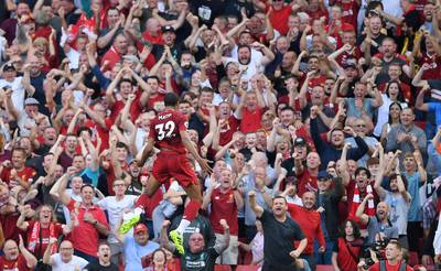 LIVERPOOL, ENGLAND - AUGUST 24: Joel Matip of Liverpool celebrates in front of the Kop after scoring the opening goal during the Premier League match between Liverpool FC and Arsenal FC at Anfield on August 24, 2019 in Liverpool, United Kingdom. (Photo by Laurence Griffiths/Getty Images)