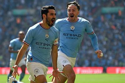 Manchester City's Ilkay Gundogan celebrates with Jack Grealish after scoring the early opening goal. AFP