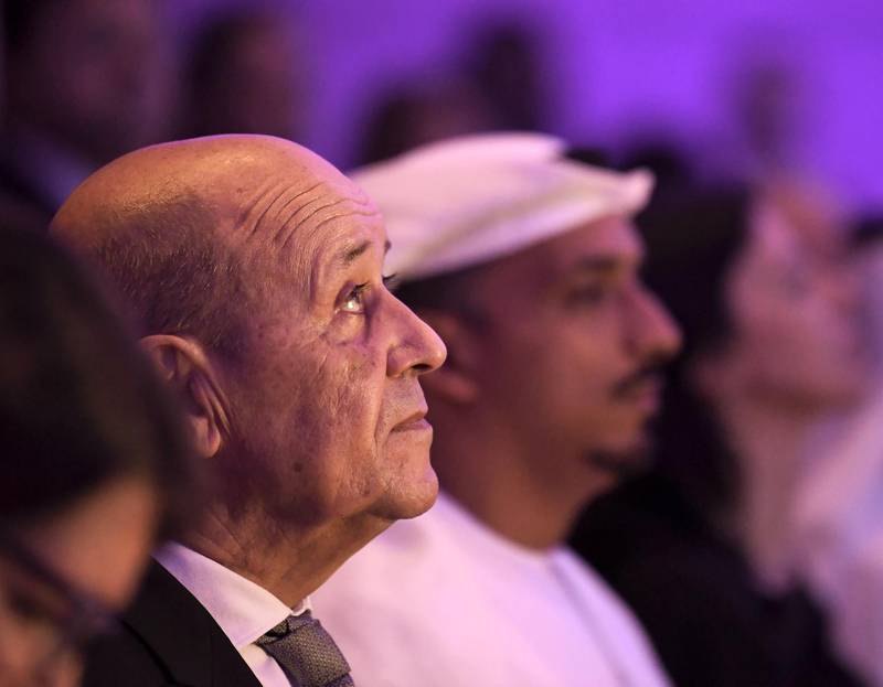 French Foreign Affairs Minister Jean-Yves Le Drian (L) listens to a speech during his visit to Abu Dhabi's Sorbonne University in the Emirati capital, on October 28, 2019.  / AFP / KARIM SAHIB
