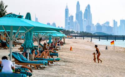 Beach-goers lie on lounge chairs by the shoreline along the Jumeirah al-Naseem beach in Dubai as coronavirus lockdown measures are eased in the emirate. AFP