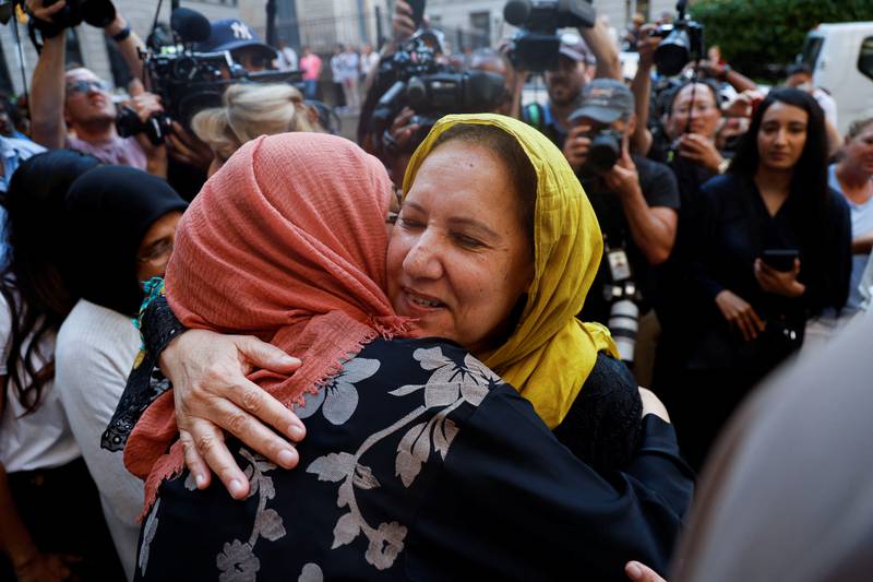 Mr Syed's mother, Shamim Syed, hugs a supporter after her son was released. Reuters