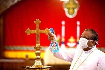 A Christian priest cleans the church area as places of worship were allowed to re-open with strict guidelines from 8 June, in, Bhopal, India. EPA