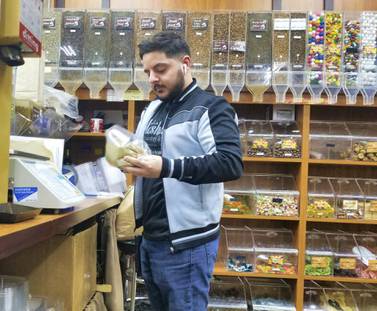 Jamal Hashem mixes a bag of zataar at his family's store in Dearborn, Detroit. Courtesy Stephen Starr