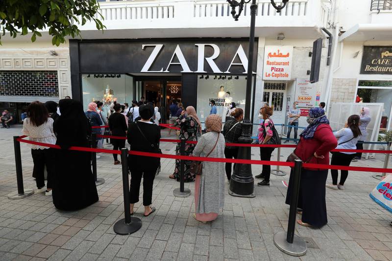Customers wearing protective face masks queue outside a Zara store before reopening on the Habib Bourguiba avenue in Tunis, Tunisia. EPA