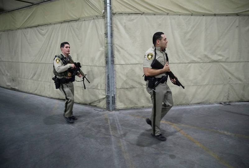 Police officers enter the Mandalay Bay resort and casino during a shooting near the Mandalay Bay resort and casino on the Las Vegas Strip. John Locher / AP Photo
