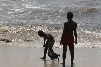 Boys play on a beach in Accra, one of the settings in Taiye Selasi's novel, Ghana Must Go, about a family that moves to the US. Luc Gnago / Reuters