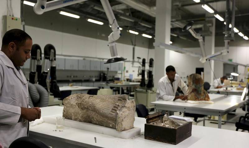Archaeologists renovate artifacts at the Grand Egyptian Museum in Giza. Mohamed Abd El Ghany / Reuters