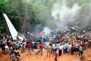 Rescuers and onlookers at the site of the Air India plane crash in Mangalore.