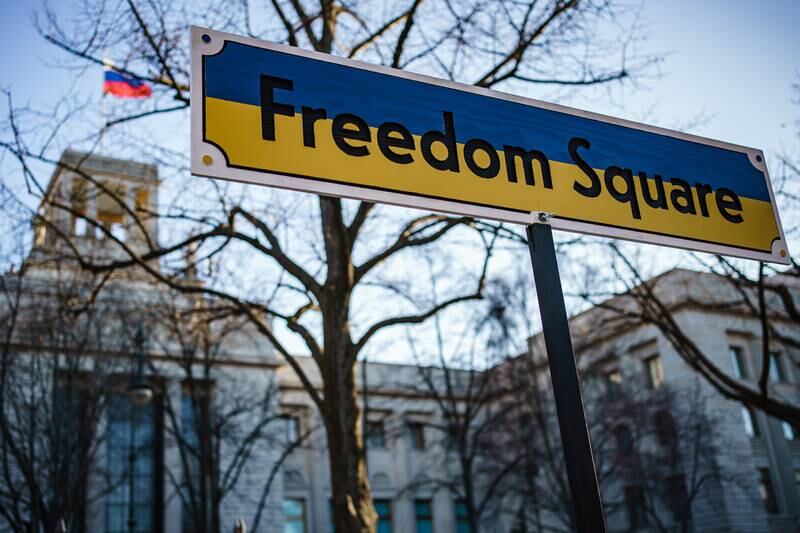 A road sign in the national colours of Ukraine, reading 'Freedom Square', stands during a demonstration in front of the Russian embassy in Berlin. EPA