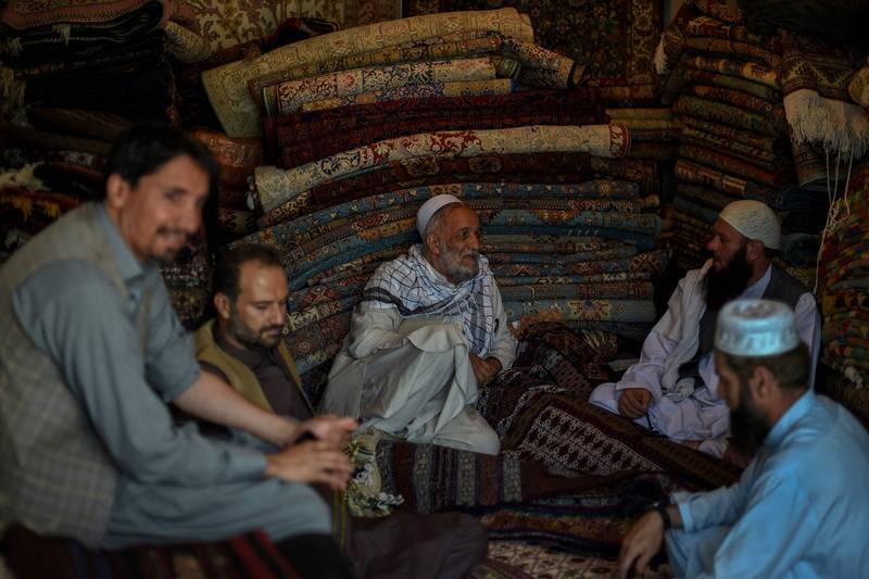 Afghan carpet vendors chat among themselves. Photo: AFP