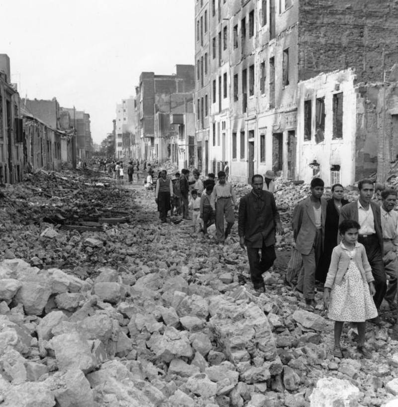 People walk through bombed streets during the Suez Crisis in 1956, which looked like it might trigger another world war. Bellamy / Getty Images