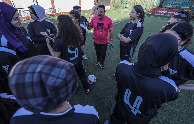 The coach talks to the players of YMCA-Gaza.  