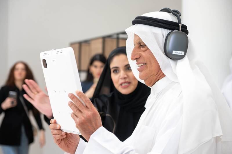 Salem Ali Al Muhairi, chairman of the Sharjah Municipal Council, tries the AR experience at the museum