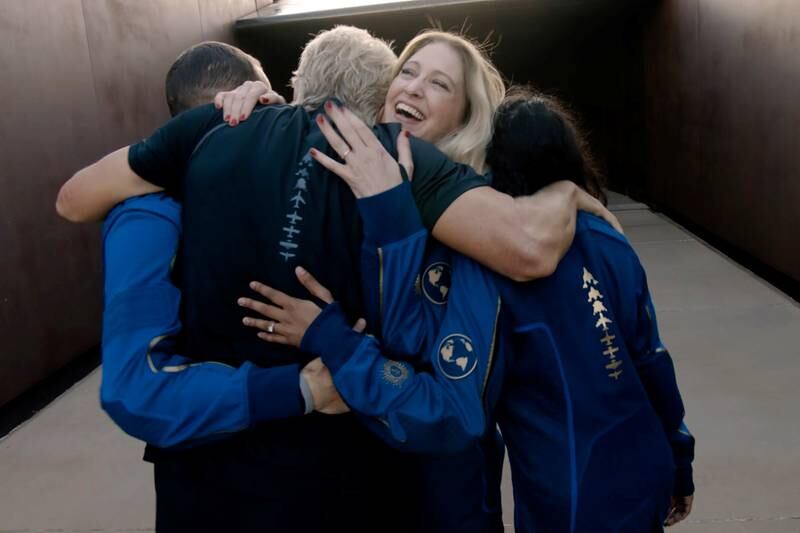 Virgin Galactic's chief astronaut instructor Beth Mose embraces Mr Branson and other crew members before boarding the 'VSS Unity'.